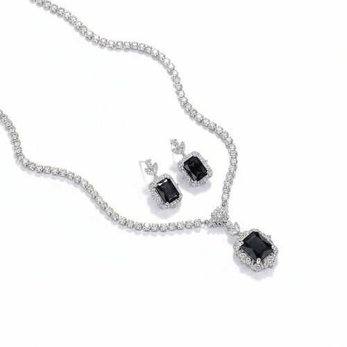 Elegant rhodium necklace and earring set with zircon accents from Bound Jewels displayed on a white background.