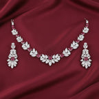 Rhodium-plated necklace and earring set featuring zircon stones, elegantly arranged in a bound jewels wreath design.