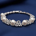Rhodium plated silver pearl bracelet by Bound Jewels, showcasing elegant pearls on a delicate chain.