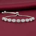 Rhodium adjustable bracelet featuring an oval halo design adorned with zircon stones by Bound Jewels.