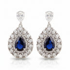 Rhodium drop-shaped earrings featuring luxury zircon stones by Bound Jewels, elegantly displayed against a soft background.